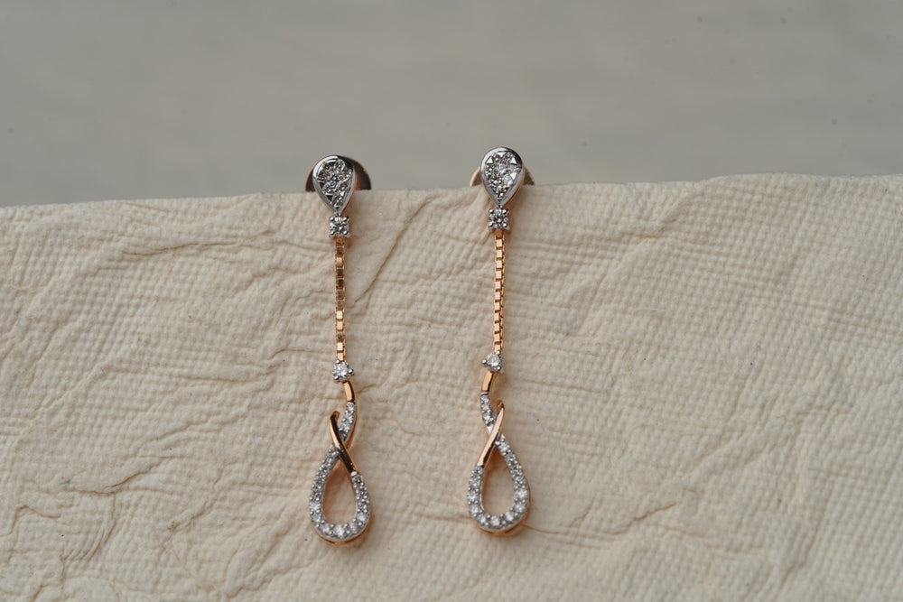 Pair of gold earrings with detailed stone settings
