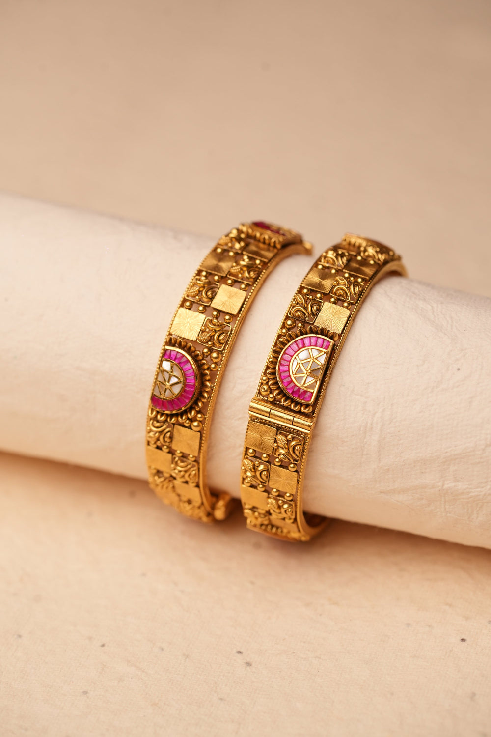 Pair of antique gold bangles on a fabric roll