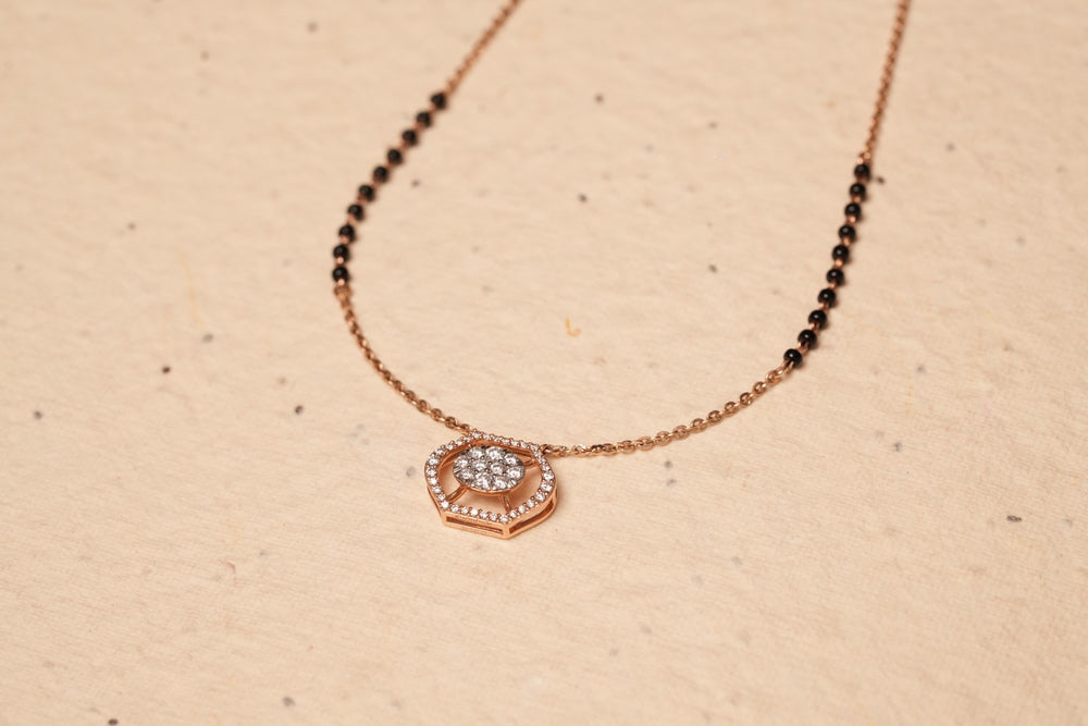 Mangalsutra necklace presented on a warm neutral surface