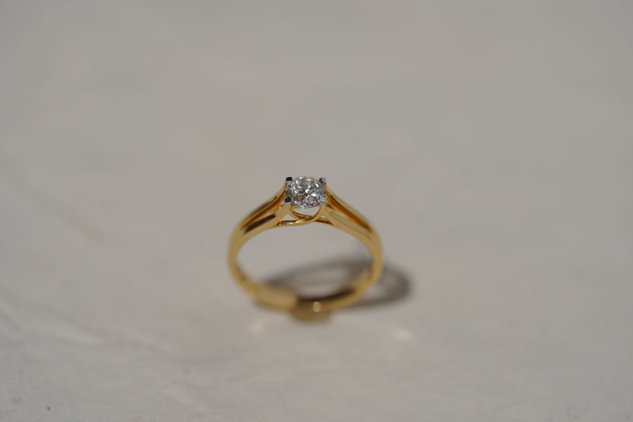 Diamond ring photographed on a neutral surface