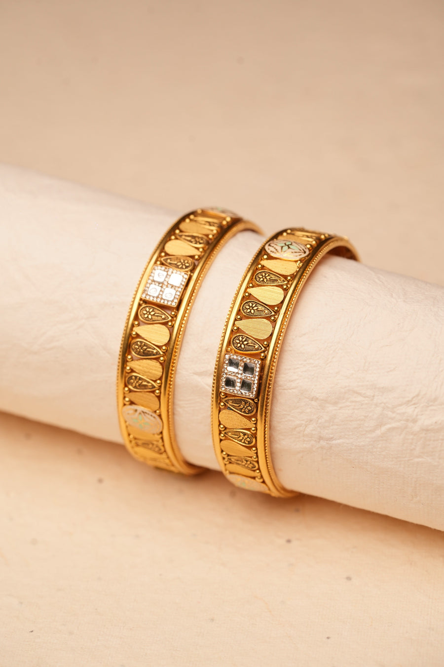 Macro view of engraved 22K gold bangles
